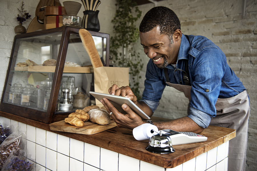 Business Insurance - Man Using Tablet for online Business order at Bakery